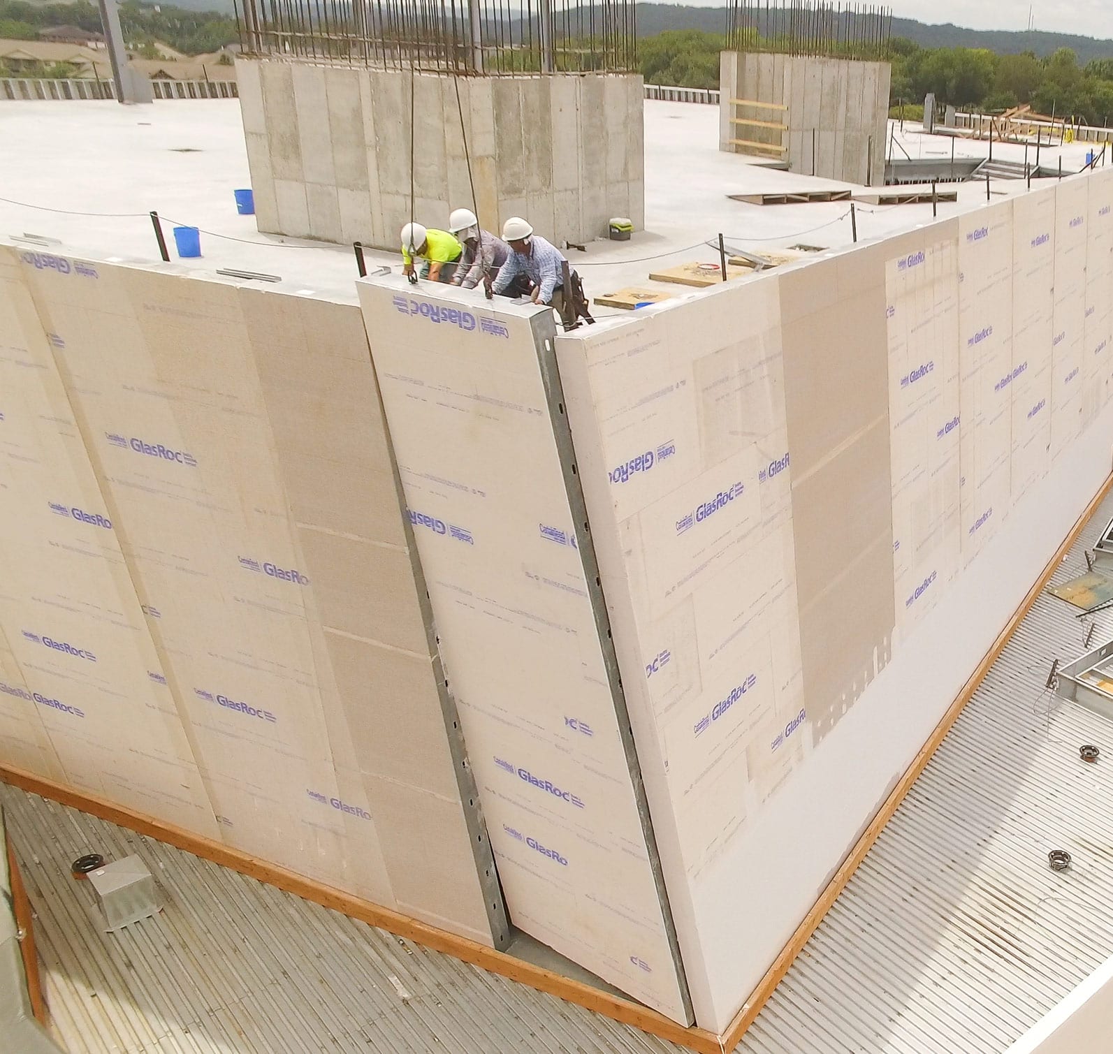 EPI construction workers install prefabricated metal panels