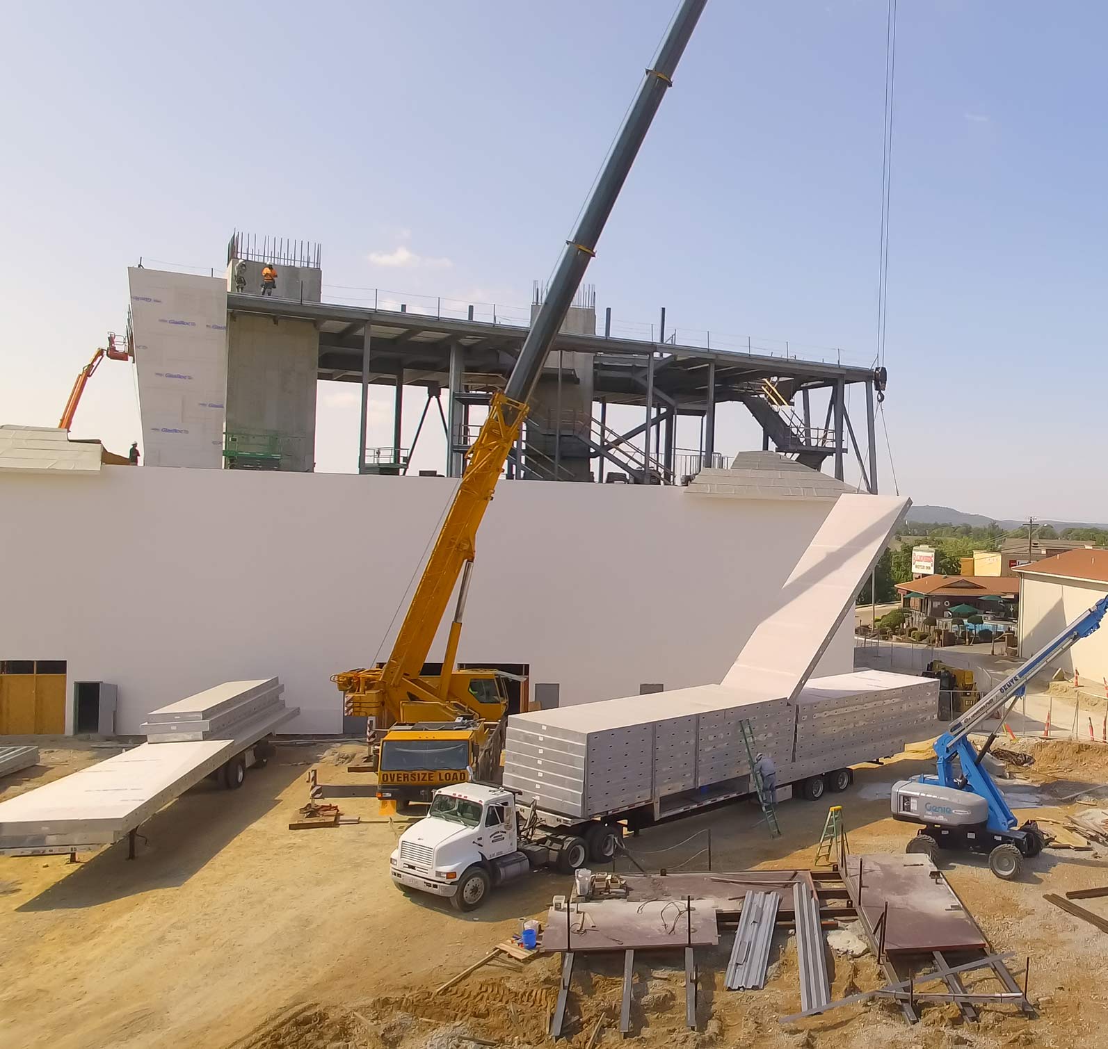 EPI construction uses a crane to hang prefabricated metal panels on site